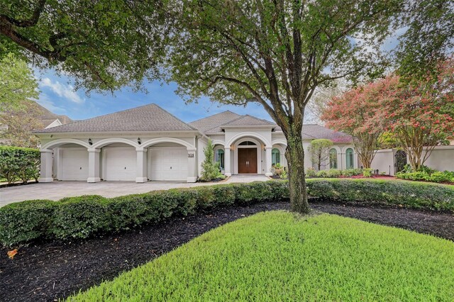 910 Peachwood Bend Dr, Houston, TX 77077 - mediterranean / spanish home with a garage, driveway, and stucco siding