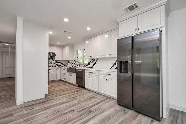 1805 E Ave, Katy, TX 77493 - kitchen featuring appliances with stainless steel finishes, white cabinets, light wood-style floors, a sink, and recessed lighting
