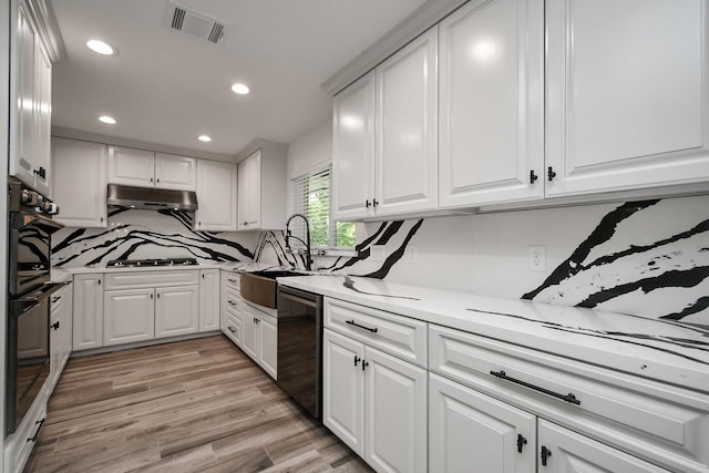 1805 E Ave, Katy, TX 77493 - kitchen with a sink, backsplash, light countertops, and recessed lighting