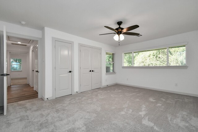 1805 E Ave, Katy, TX 77493 - unfurnished bedroom featuring attic access, carpet floors, multiple windows, and baseboards