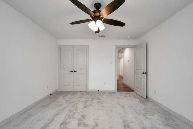 1805 E Ave, Katy, TX 77493 - unfurnished bedroom with carpet, baseboards, a ceiling fan, and a closet