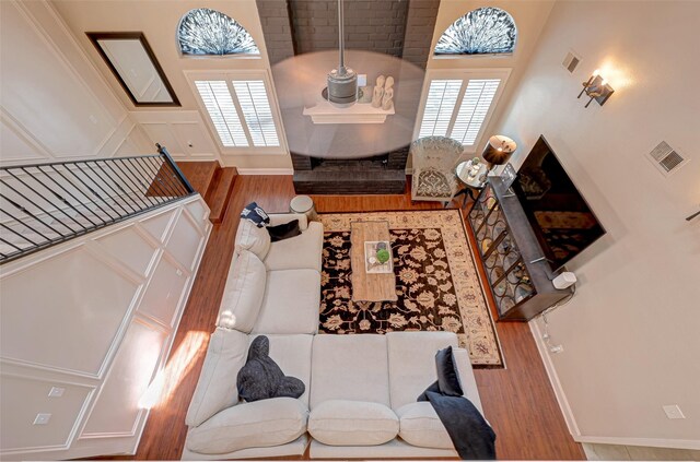 living room with wood finished floors, plenty of natural light, and baseboards