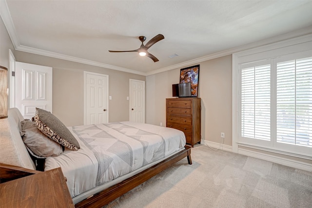 bedroom with light colored carpet, ornamental molding, a ceiling fan, and baseboards