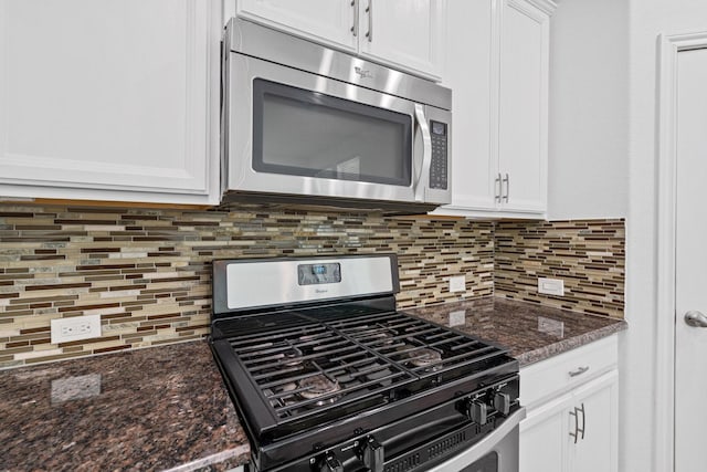 326 Lake Rim Dr, Rosenberg, TX 77469 - kitchen with appliances with stainless steel finishes, white cabinets, decorative backsplash, and dark stone countertops