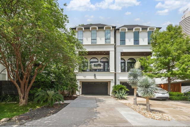 3226 Leonidas St, Houston, TX 77019 - view of front of home featuring a balcony, stucco siding, a garage, and driveway