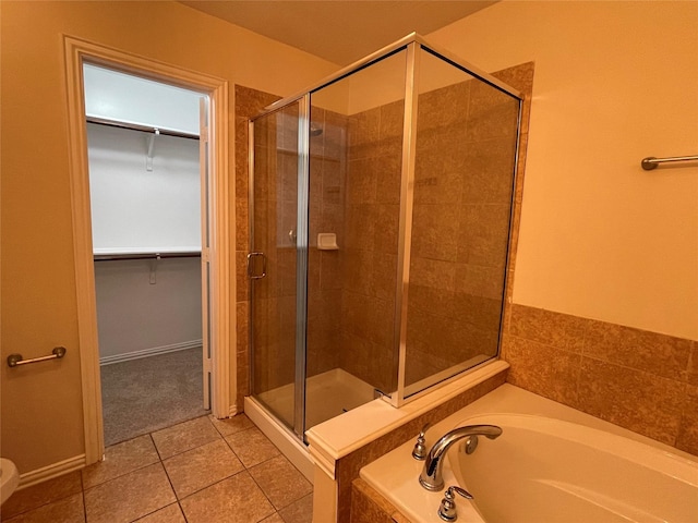 11317 Elegant Way, Houston, TX 77066 - bathroom with a shower stall, tile patterned flooring, a spacious closet, and a garden tub