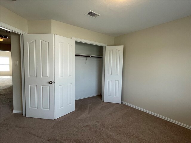 11317 Elegant Way, Houston, TX 77066 - unfurnished bedroom with carpet flooring, baseboards, and a closet