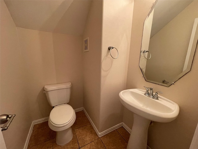 11317 Elegant Way, Houston, TX 77066 - bathroom with tile patterned floors, toilet, baseboards, and vaulted ceiling