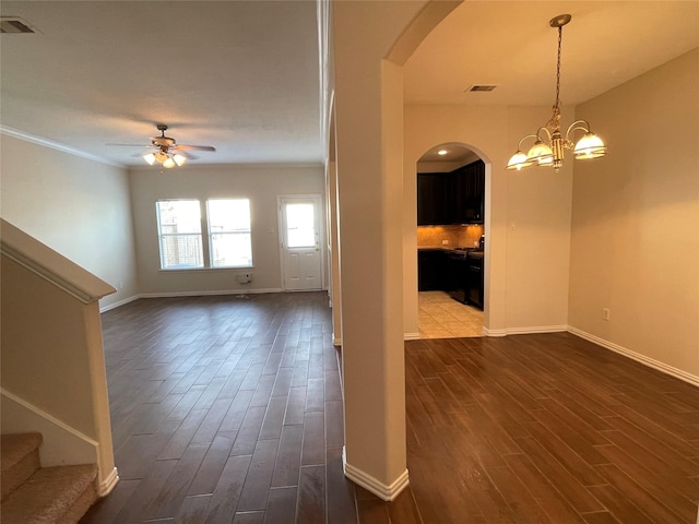 11317 Elegant Way, Houston, TX 77066 - spare room featuring arched walkways, a ceiling fan, dark wood finished floors, baseboards, and ornamental molding