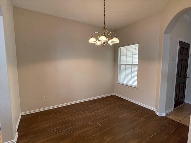 11317 Elegant Way, Houston, TX 77066 - empty room with arched walkways, dark wood-style floors, a chandelier, and baseboards