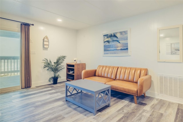 living room with wood finished floors, baseboards, and recessed lighting