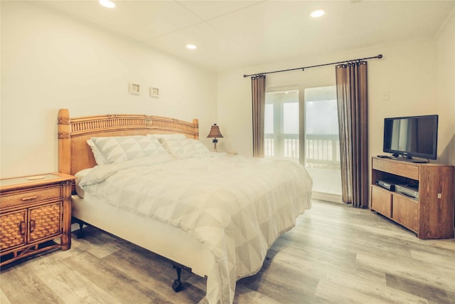 bedroom featuring access to outside, light wood-type flooring, and recessed lighting