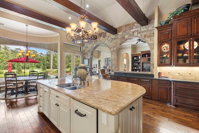 38 Post Shadow Estate Dr, Spring, TX 77389 - kitchen featuring a chandelier, a sink, dark wood-type flooring, beamed ceiling, and a center island with sink