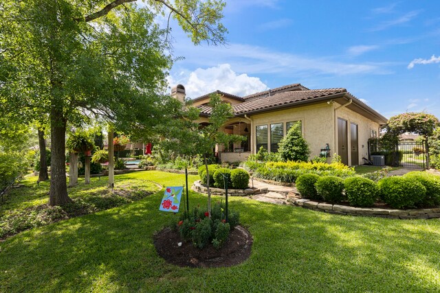 38 Post Shadow Estate Dr, Spring, TX 77389 - rear view of house featuring cooling unit, a chimney, stucco siding, and a tiled roof
