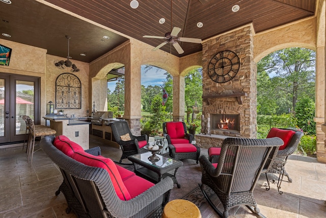 38 Post Shadow Estate Dr, Spring, TX 77389 - view of patio with french doors, an outdoor living space with a fireplace, and a ceiling fan