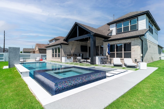rear view of house with an in-ground hot tub, brick siding, a patio, an outdoor kitchen, and a shingled roof