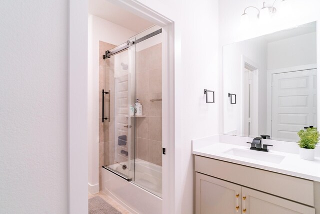 bathroom featuring vanity and combined bath / shower with glass door