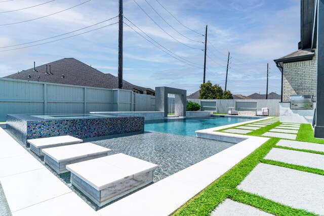 view of pool featuring a grill, a fenced backyard, area for grilling, and a patio