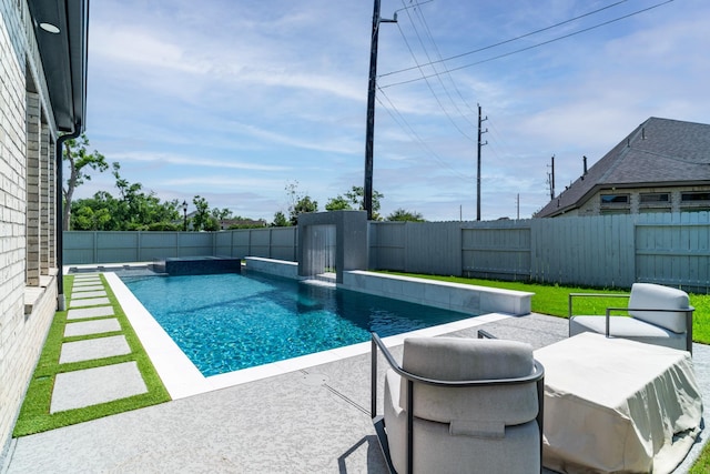 view of swimming pool featuring a fenced backyard and a patio area