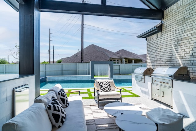 view of patio featuring area for grilling, exterior kitchen, and a fenced backyard