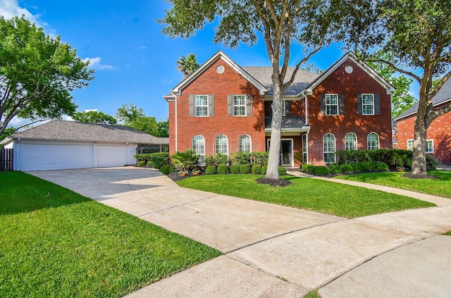 14 Wickham Ct, Sugar Land, TX 77479 - colonial house with a garage, a front yard, brick siding, and driveway