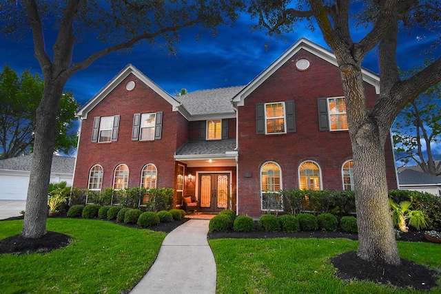 14 Wickham Ct, Sugar Land, TX 77479 - georgian-style home with french doors, brick siding, and a front yard