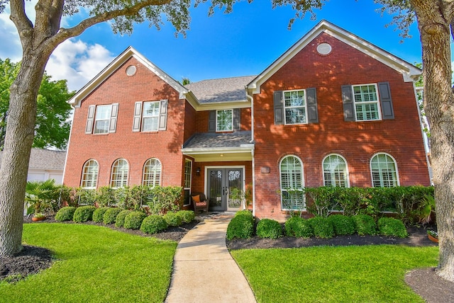 14 Wickham Ct, Sugar Land, TX 77479 - colonial inspired home with french doors, brick siding, and a front yard