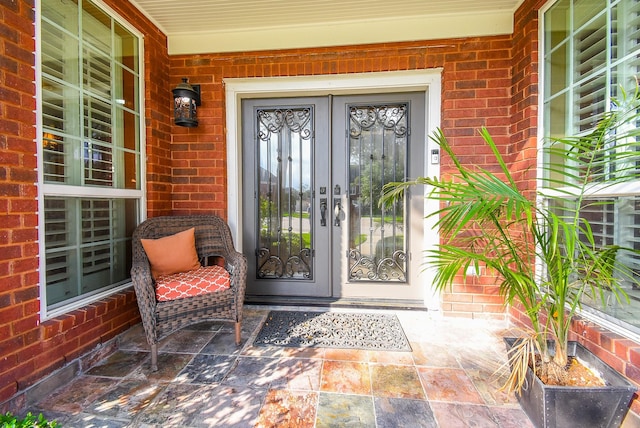 14 Wickham Ct, Sugar Land, TX 77479 - doorway to property with brick siding, french doors, and a porch