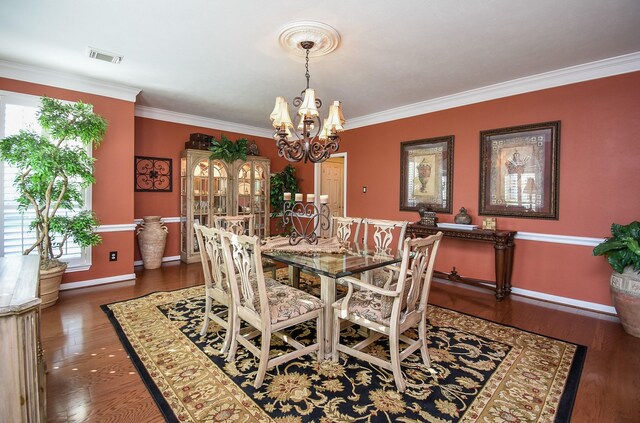 14 Wickham Ct, Sugar Land, TX 77479 - dining area featuring a chandelier, wood finished floors, crown molding, and baseboards