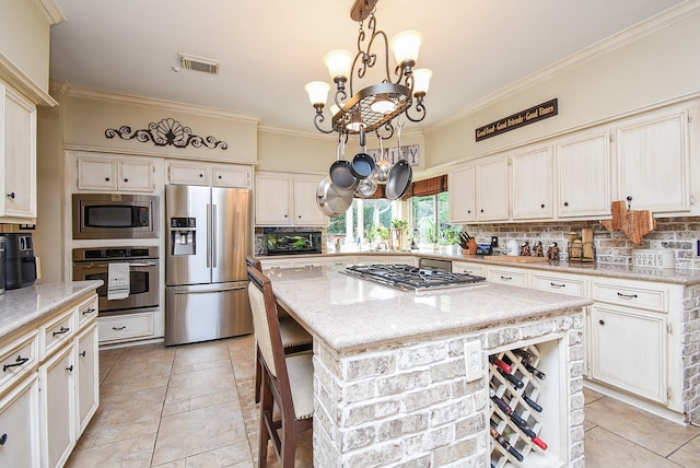 14 Wickham Ct, Sugar Land, TX 77479 - kitchen with appliances with stainless steel finishes, a chandelier, crown molding, tasteful backsplash, and light stone counters