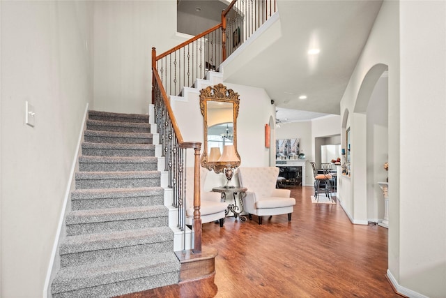 4635 Countrymeadows Dr, Spring, TX 77388 - stairway featuring a towering ceiling, wood finished floors, baseboards, and arched walkways