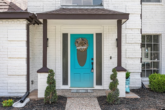 15115 Gladebrook Dr, Houston, TX 77068 - property entrance with roof with shingles and brick siding