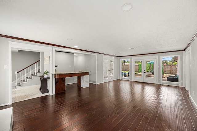 15115 Gladebrook Dr, Houston, TX 77068 - unfurnished living room with wood finished floors, ornamental molding, stairway, baseboards, and french doors