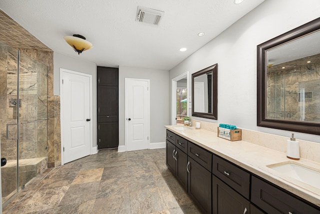15115 Gladebrook Dr, Houston, TX 77068 - full bath with a shower stall, double vanity, recessed lighting, stone finish floors, and baseboards