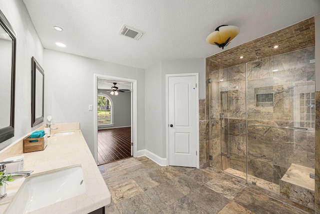 15115 Gladebrook Dr, Houston, TX 77068 - full bath featuring a shower stall, baseboards, double vanity, stone finish flooring, and a ceiling fan