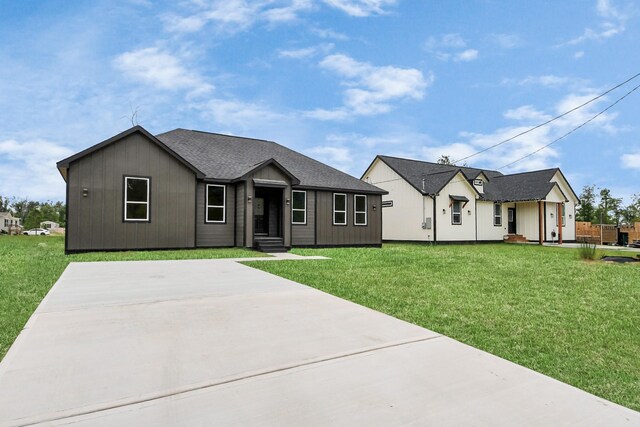 1029 Gazing Pine St, Huffman, TX 77336 - view of front facade featuring a front lawn and roof with shingles