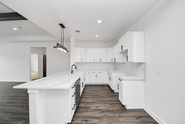 1029 Gazing Pine St, Huffman, TX 77336 - kitchen featuring a peninsula, decorative backsplash, dark wood-type flooring, white cabinetry, and recessed lighting