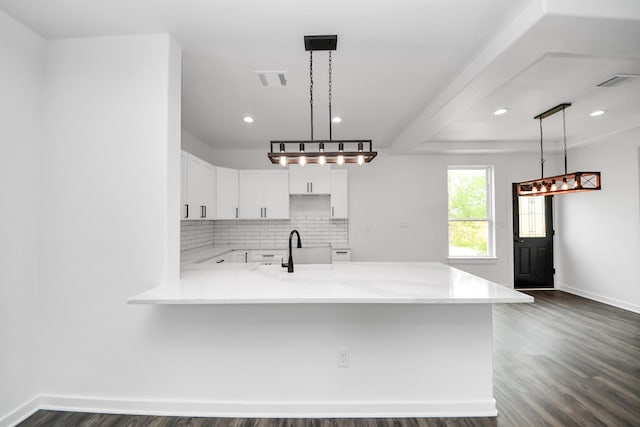 1029 Gazing Pine St, Huffman, TX 77336 - kitchen with a peninsula, dark wood-style flooring, backsplash, white cabinets, and baseboards