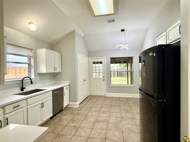 5223 Mountain Forest Dr, Katy, TX 77449 - kitchen with freestanding refrigerator, stainless steel dishwasher, a sink, vaulted ceiling, and white cabinetry