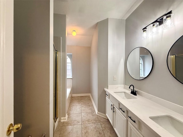 5223 Mountain Forest Dr, Katy, TX 77449 - bathroom featuring tile patterned flooring, a shower with door, double vanity, baseboards, and a tub to relax in