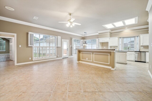 kitchen with dishwasher, light tile patterned flooring, crown molding, and decorative backsplash