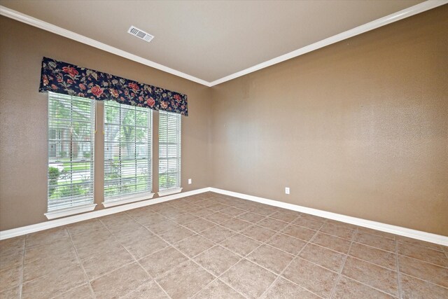empty room with ornamental molding and baseboards