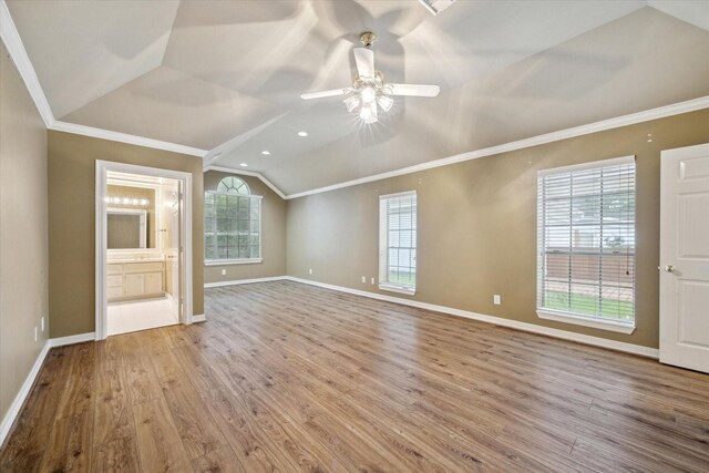 unfurnished living room with lofted ceiling, ceiling fan, wood finished floors, baseboards, and ornamental molding
