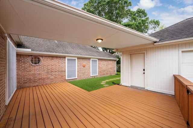 wooden deck with a lawn