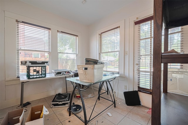 home office with light tile patterned floors and baseboards