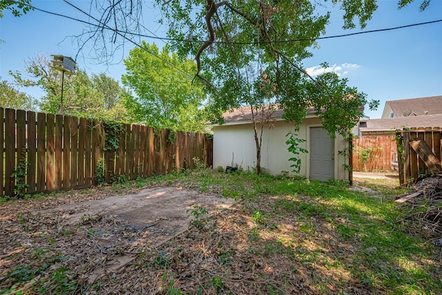 fenced backyard with an outdoor structure