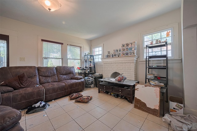 living area featuring light tile patterned floors and a brick fireplace