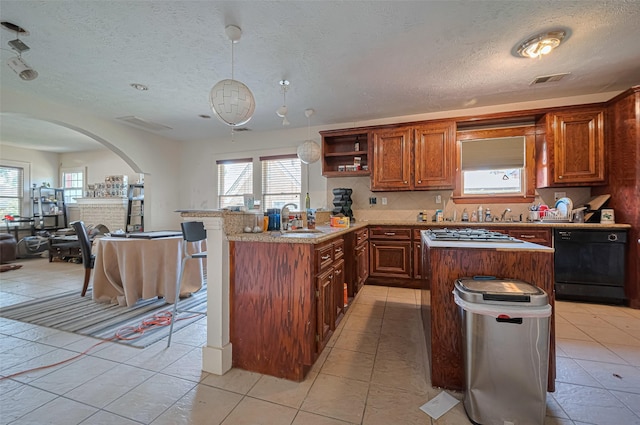 kitchen with dishwasher, arched walkways, a sink, a peninsula, and open floor plan
