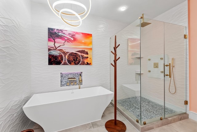 1 Waterway Ct Unit 4B, The Woodlands, TX 77380 - full bathroom featuring a shower stall, tile patterned flooring, a freestanding bath, and tile walls