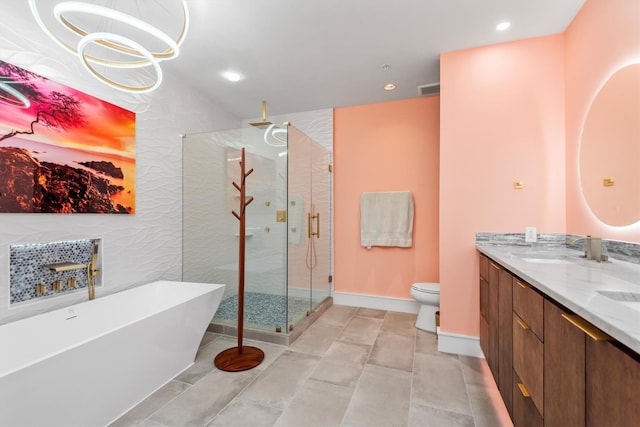 1 Waterway Ct Unit 4B, The Woodlands, TX 77380 - bathroom featuring a shower stall, a freestanding bath, double vanity, recessed lighting, and toilet